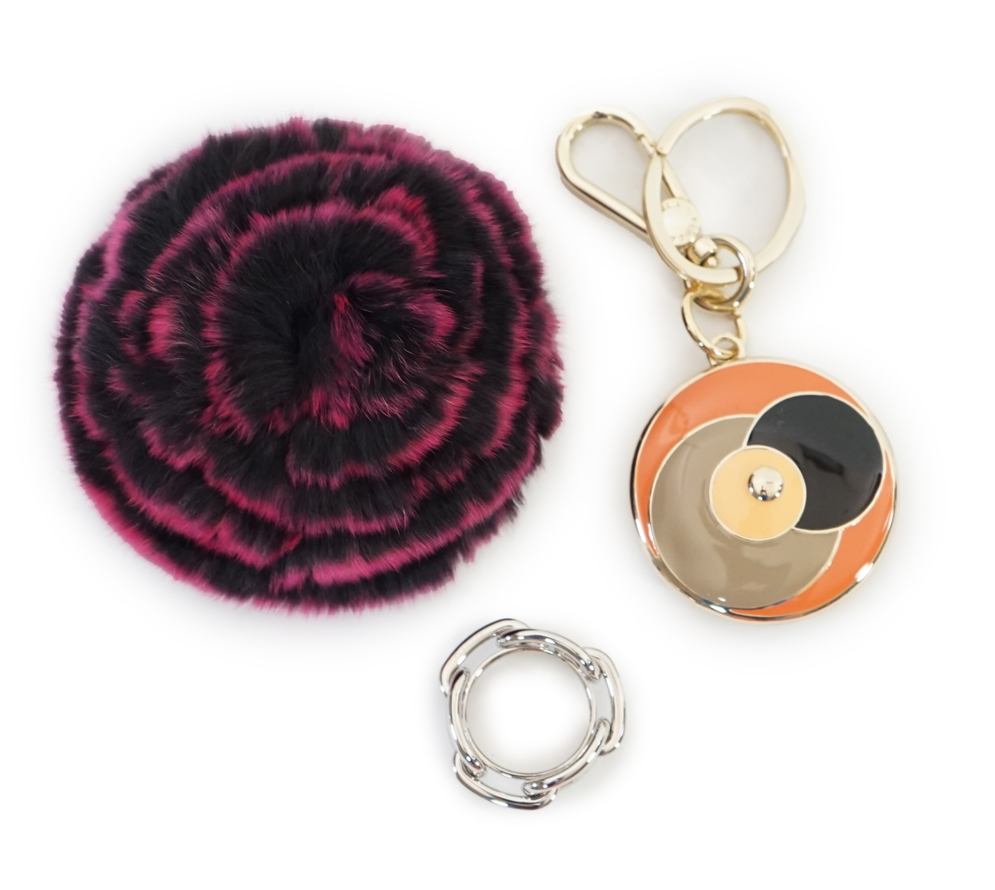 A boxed Hermes scarf ring, with box and bag and a Furla key ring and fur brooch.